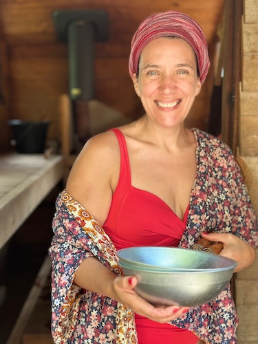 Maeve, owner of Redbarn Cavehill, standing at the entrance to the sauna.